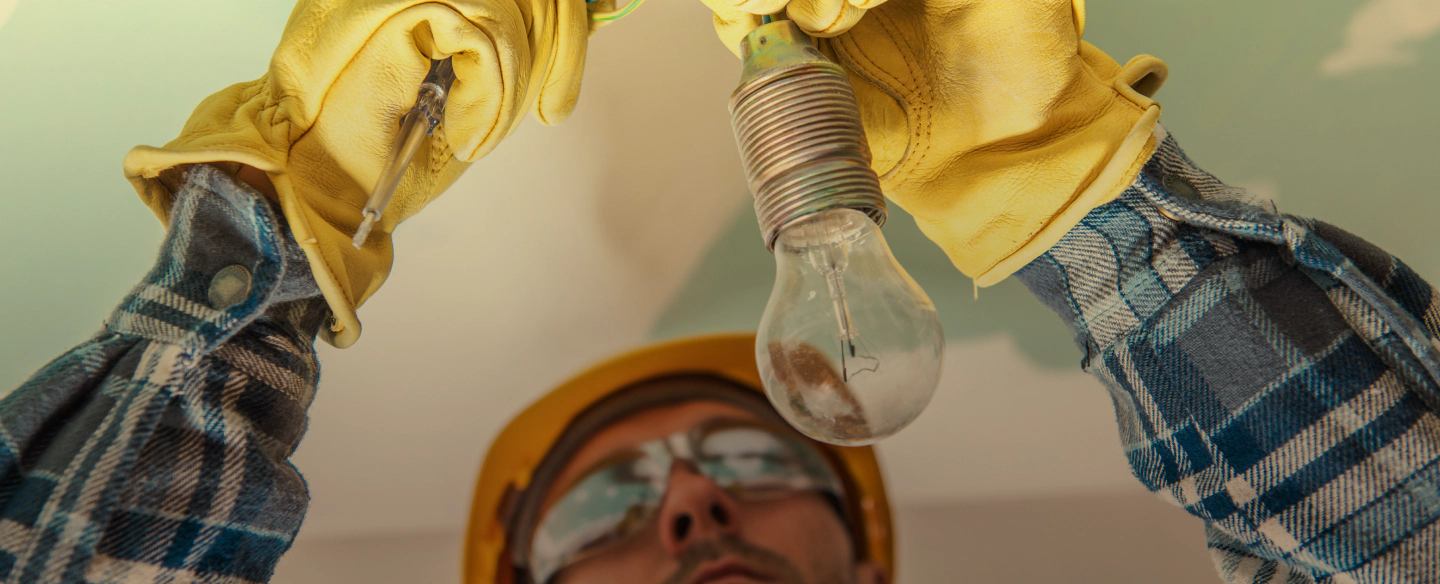 man installing light bulb